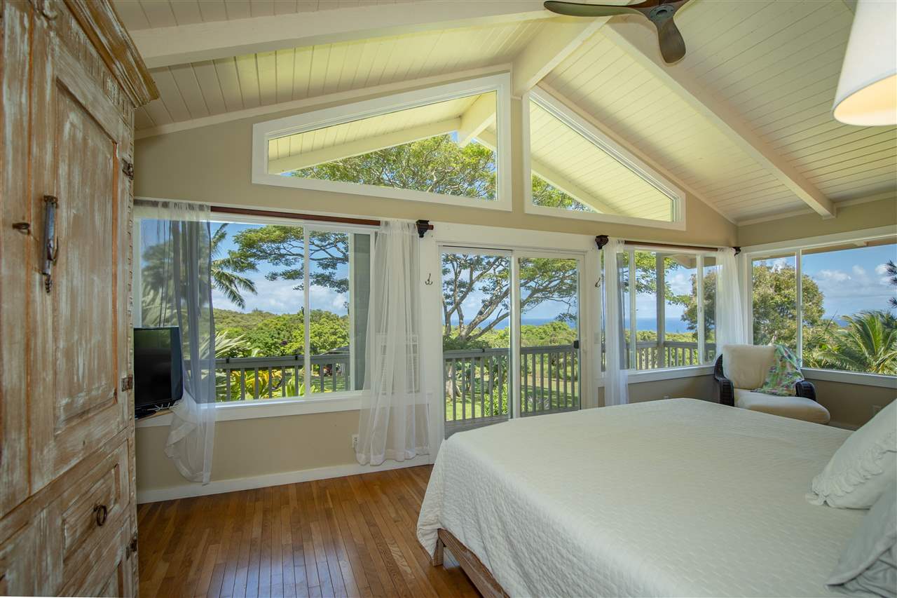 475 Haumana Road Haiku, HI 96708 - Photo 16 of 30 a bed sitting in a bedroom next to a window