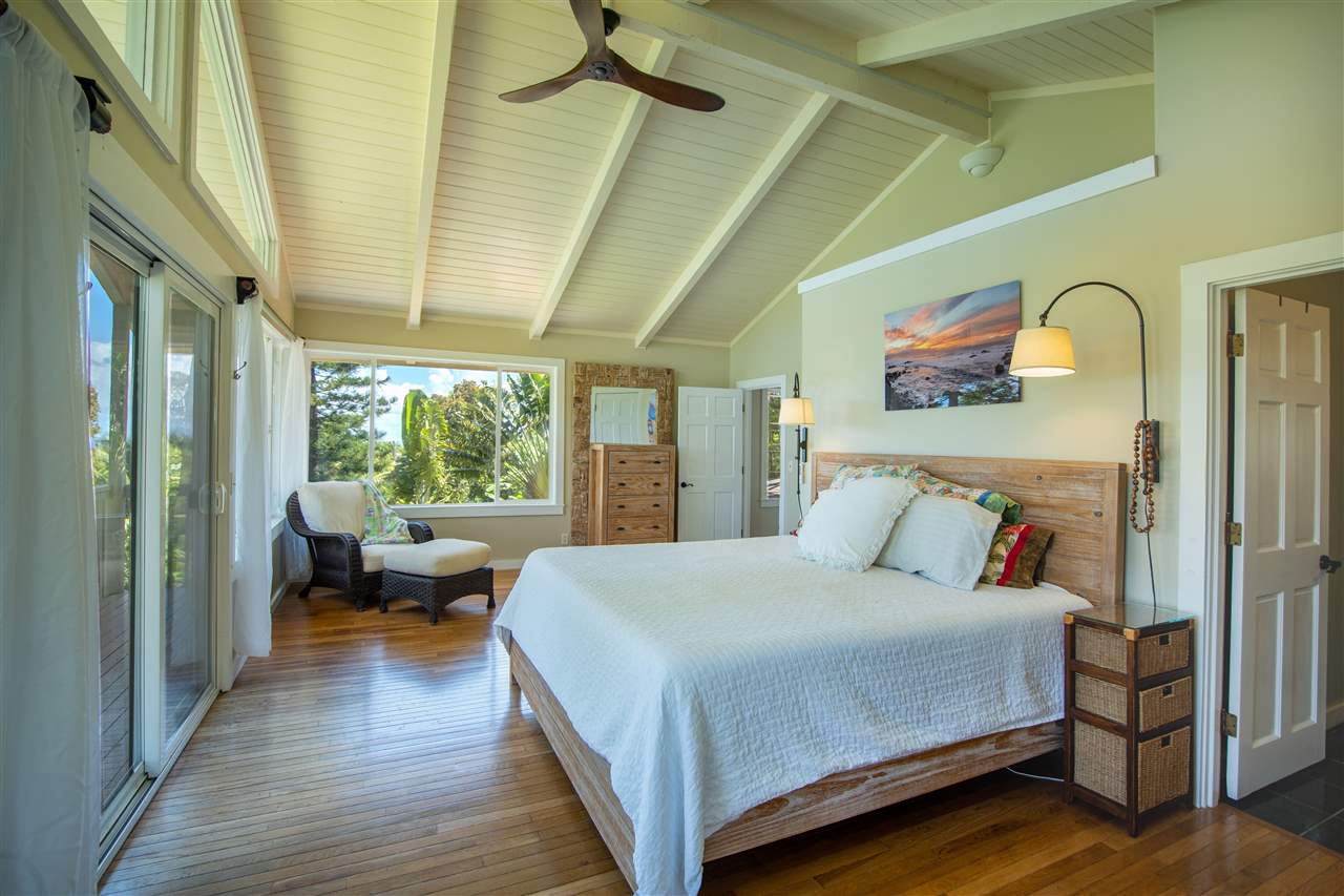 475 Haumana Road Haiku, HI 96708 - Photo 17 of 30 a bedroom with a bed couch and a large window