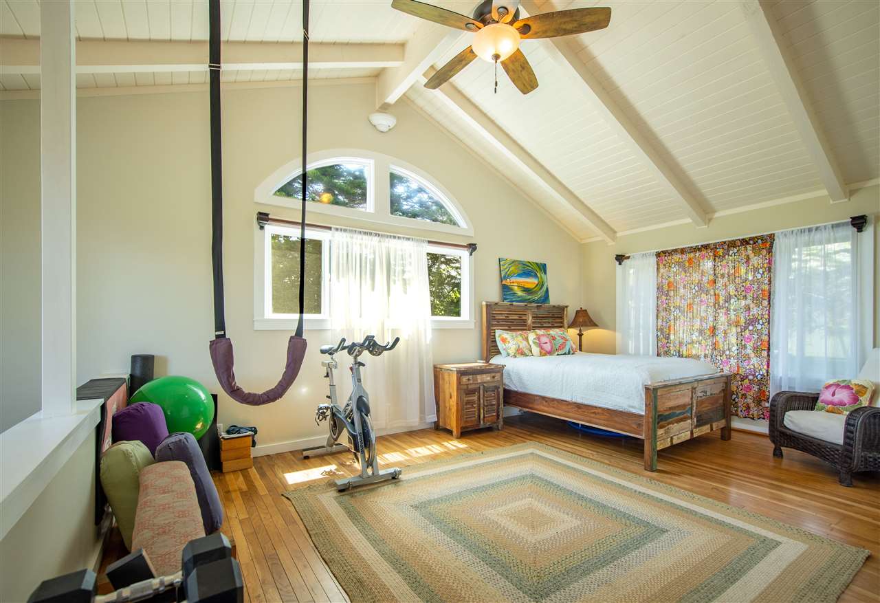 475 Haumana Road Haiku, HI 96708 - Photo 19 of 30 a bedroom with furniture and a chandelier