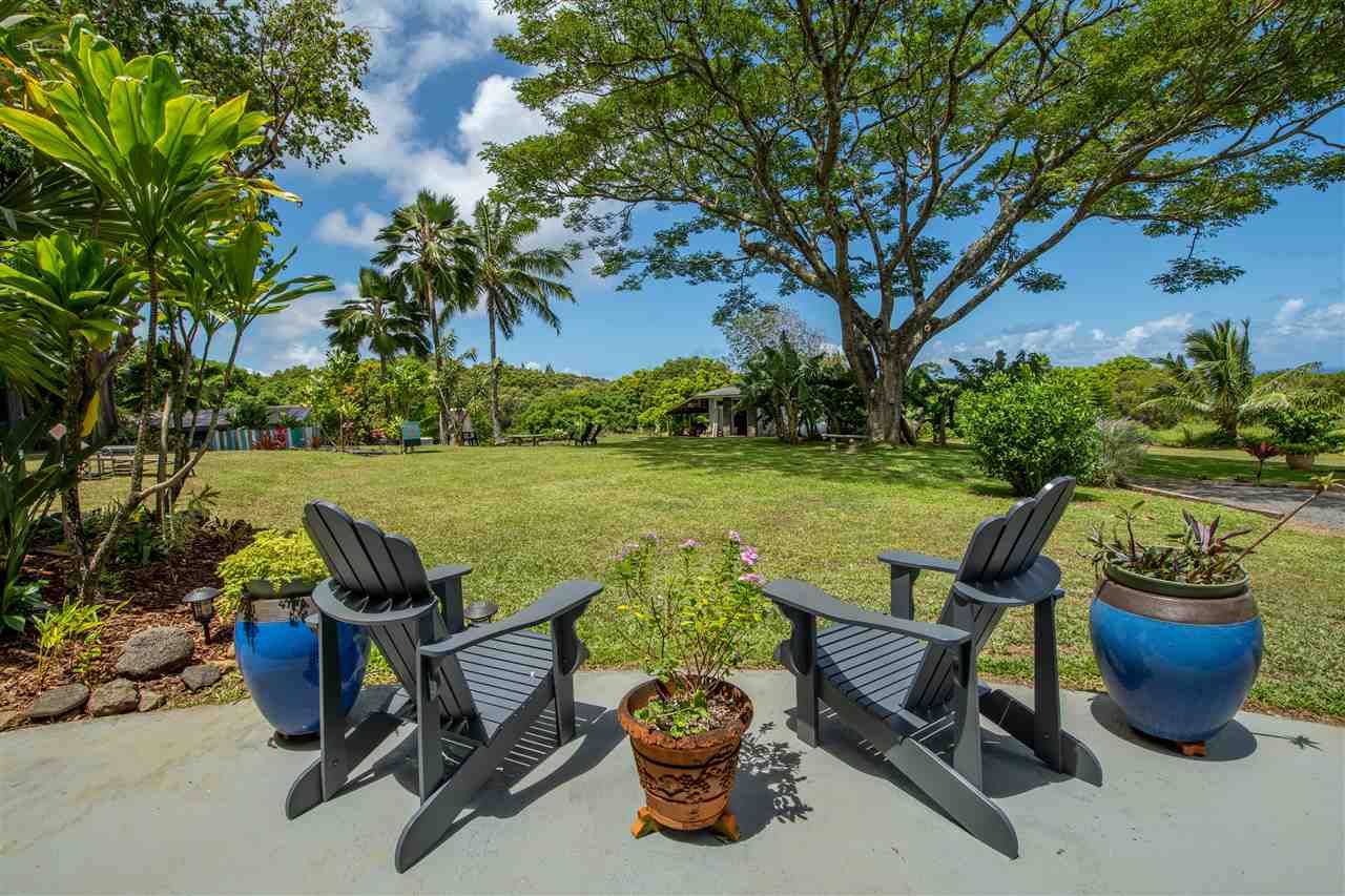 475 Haumana Road Haiku, HI 96708 - Photo 2 of 30 a view of a lake with table and chairs potted plants and lake view