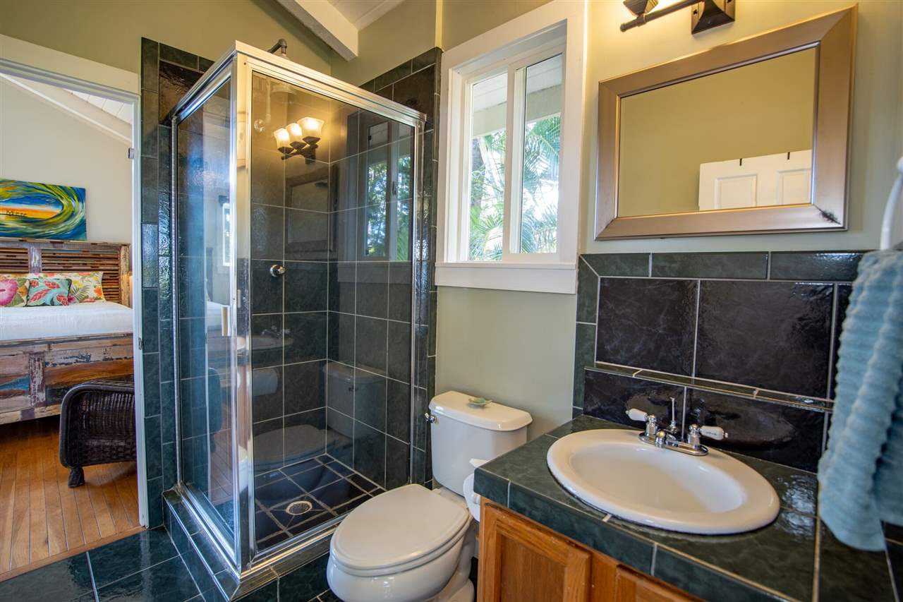 475 Haumana Road Haiku, HI 96708 - Photo 21 of 30 a bathroom with a sink toilet a mirror and shower
