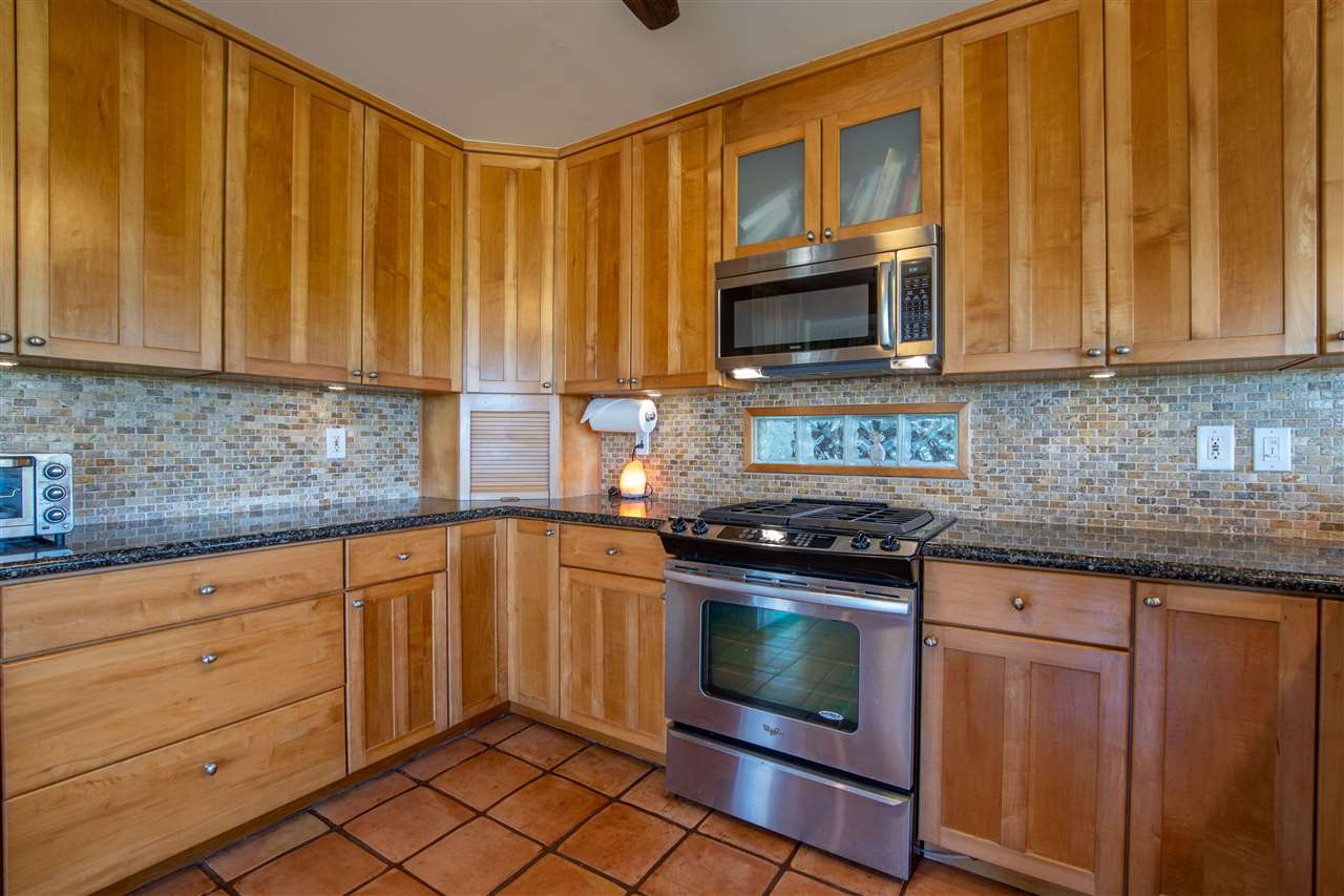 475 Haumana Road Haiku, HI 96708 - Photo 9 of 30 a kitchen with granite countertop cabinets stainless steel appliances and a sink
