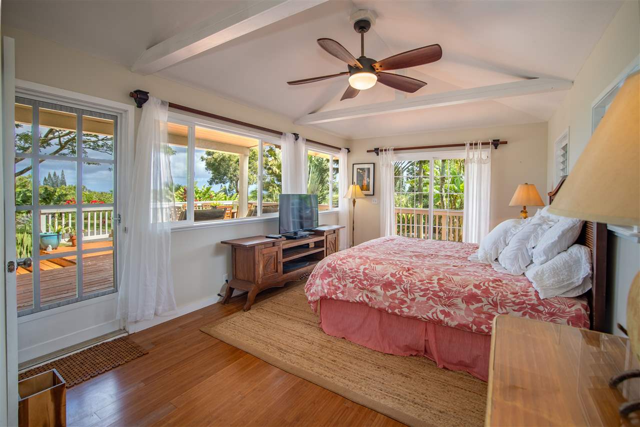 475 Haumana Road Haiku, HI 96708 - Photo 10 of 30 a bedroom with a large bed and a large window