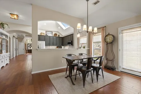 a dining room with furniture window and wooden floor