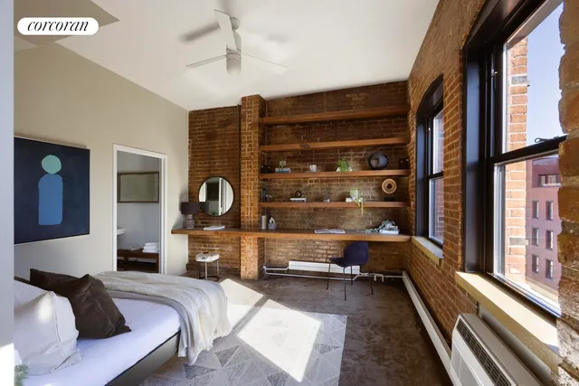 a bedroom with bed and painting on the wall