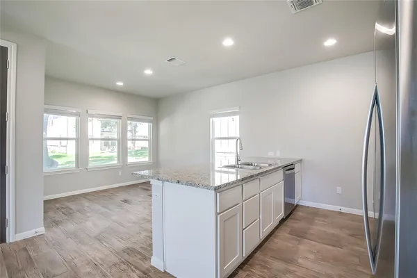 a kitchen with granite countertop a stove and a sink