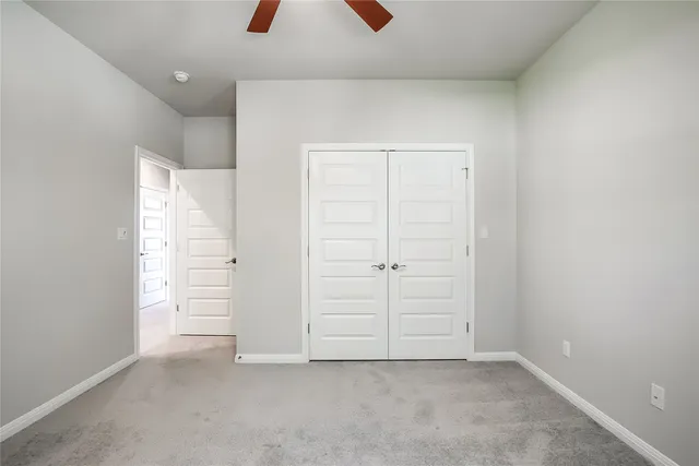 an empty room with closet and window