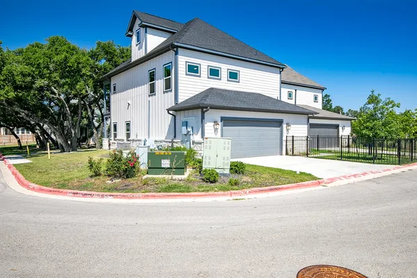 a front view of house with outdoor space and trees