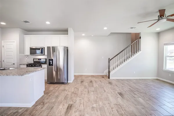 a view of a kitchen with a sink and a refrigerator