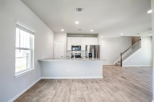 a view of kitchen with furniture and wooden floor