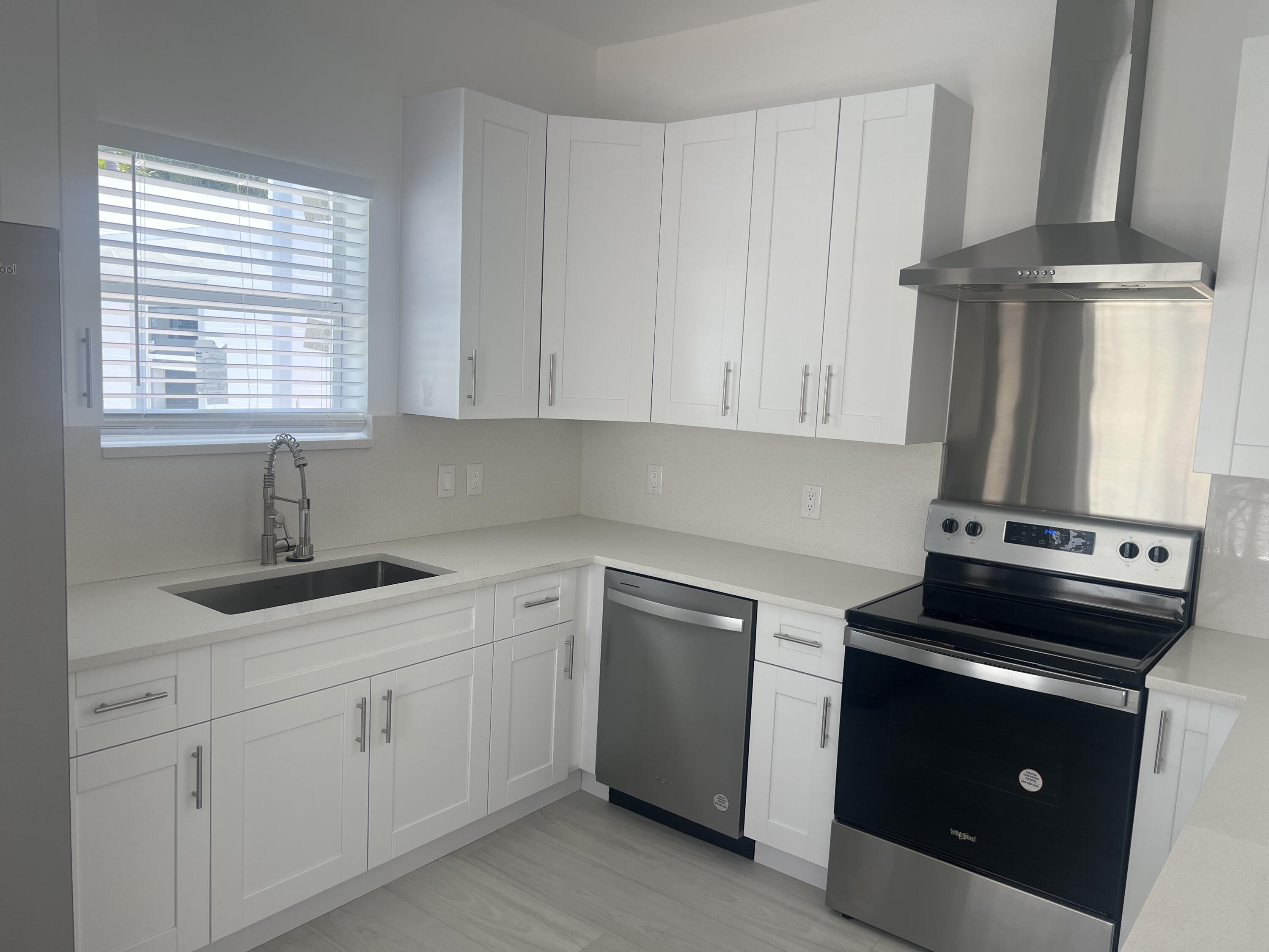 328 Nottingham Boulevard West Palm Beach, FL 33405 - Photo 11 of 22 a kitchen with cabinets appliances and a window
