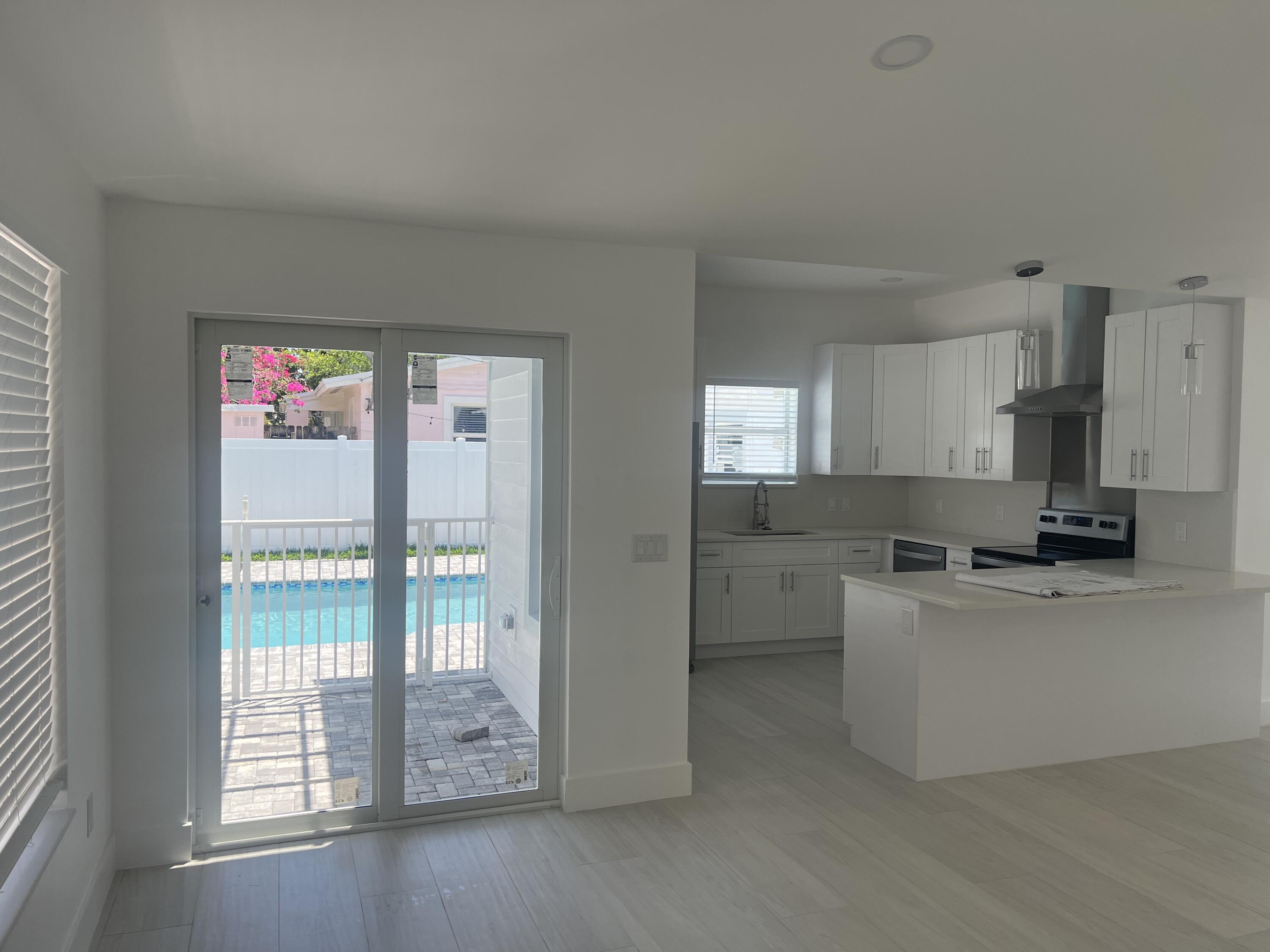 328 Nottingham Boulevard West Palm Beach, FL 33405 - Photo 12 of 22 a kitchen with cabinets a sink and appliances