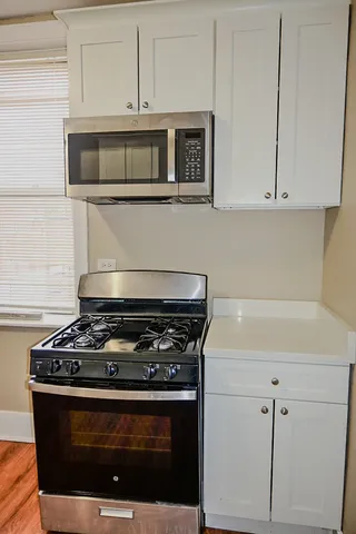 a stove top oven sitting inside of a kitchen