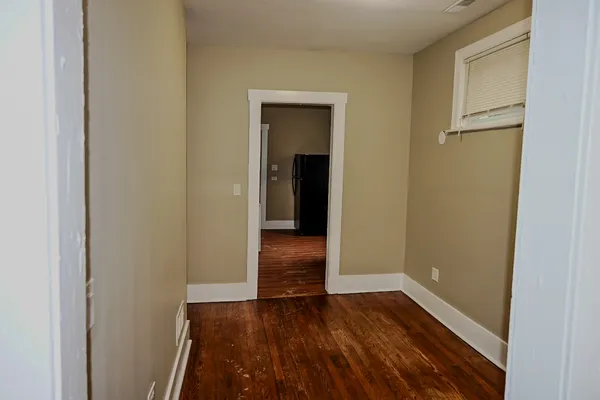 a view of a room with wooden floor