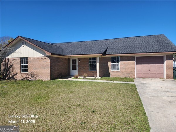 1452 Victory Drive Hinesville, GA 31313 - Photo 1 of 1 a front view of a house with a garden