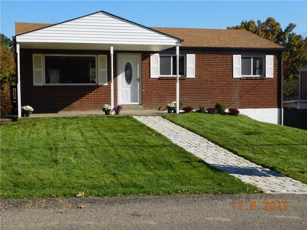 41 Highbury Road Cheswick, PA 15024 - Photo 1 of 19 a front view of a house with a yard