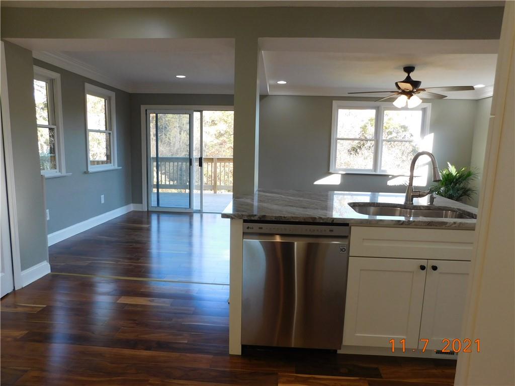41 Highbury Road Cheswick, PA 15024 - Photo 12 of 19 a kitchen with granite countertop a sink window and wooden floor