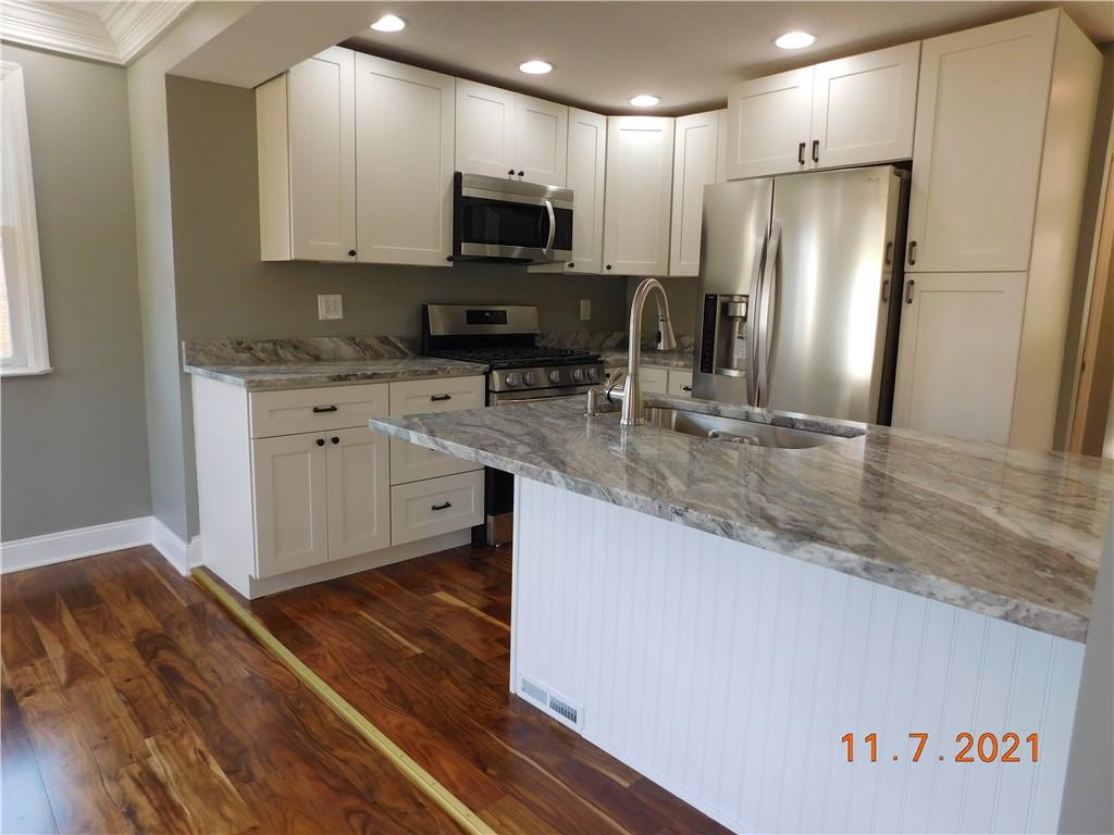 41 Highbury Road Cheswick, PA 15024 - Photo 9 of 19 a kitchen with stainless steel appliances granite countertop a refrigerator a stove top oven a sink and dishwasher