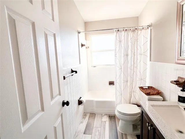 a white toilet sitting next to a bathroom sink