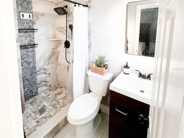 a bathroom with a sink toilet and shower