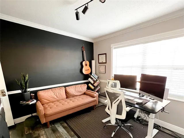 a living room with furniture a air conditioner and a window