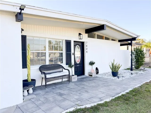 a view of a house with backyard and sitting area