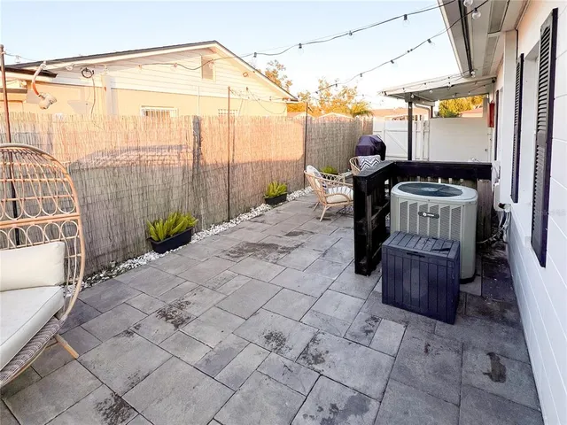 a backyard of a house with chairs