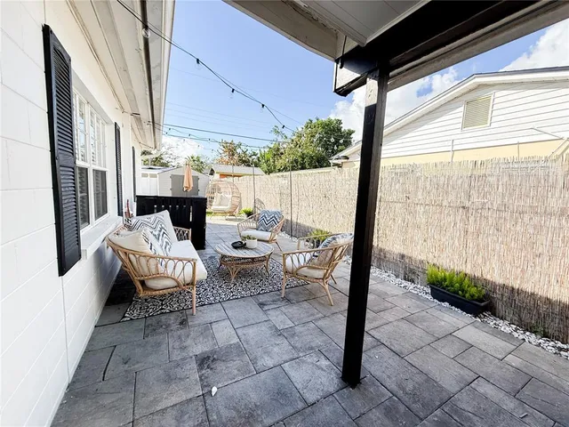 a outdoor space with patio couch and glass door