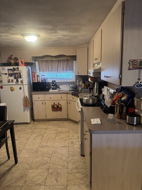 a kitchen with a sink a stove and cabinets