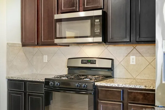 a stove top oven sitting inside of a kitchen