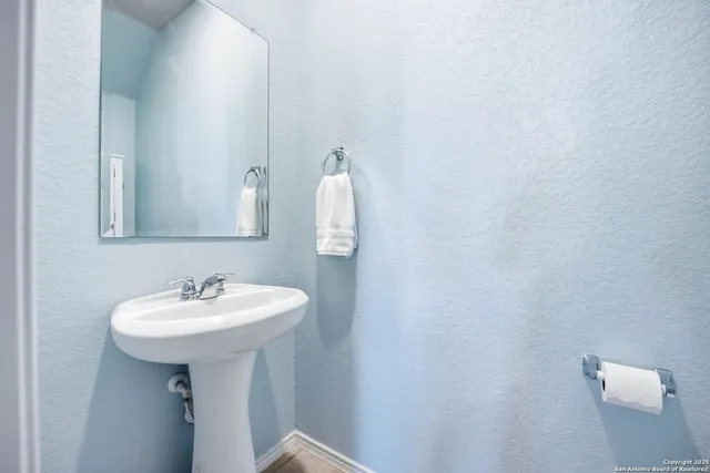 a bathroom with a sink and mirror