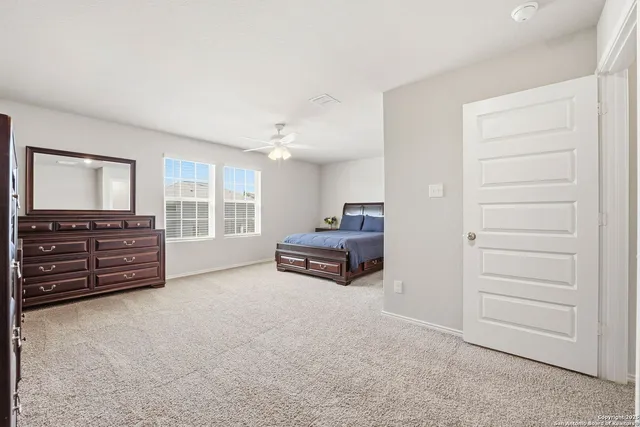 a living room with furniture and a dresser
