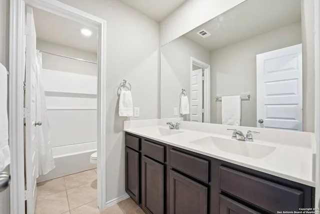 a bathroom with a sink double vanity and a mirror