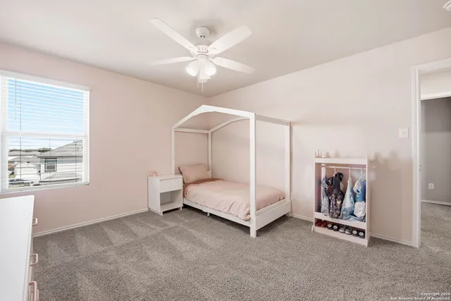 a spacious bedroom with a bed and a chandelier