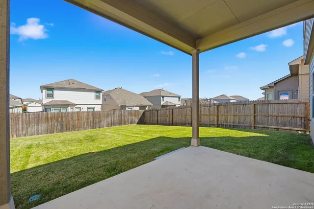 a view of a big yard with a small pool