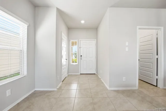 a view of a hallway to rooms and stairs