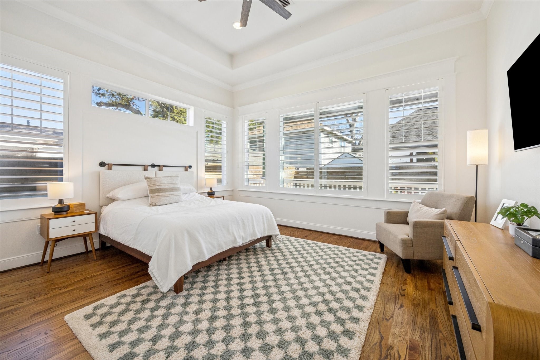 304 Walton Street Houston, TX 77009 - Photo 15 of 28 The oversized primary bedroom has beautiful hardwood floors, plantation shutters to enjoy the outside view or close off for a bit of relaxation with a book or your favorite show.