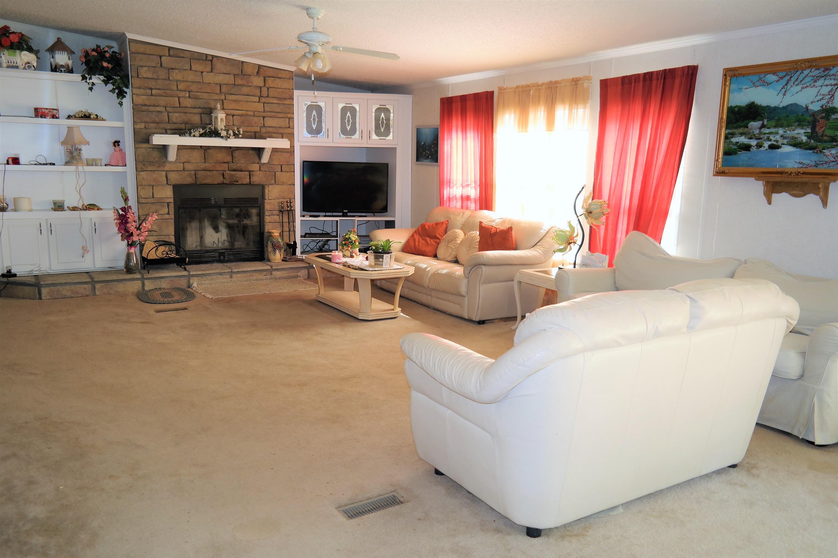 846 Elmwood Road DeFuniak Springs, FL 32433 - Photo 54 of 68 a living room with furniture a fireplace and a flat screen tv