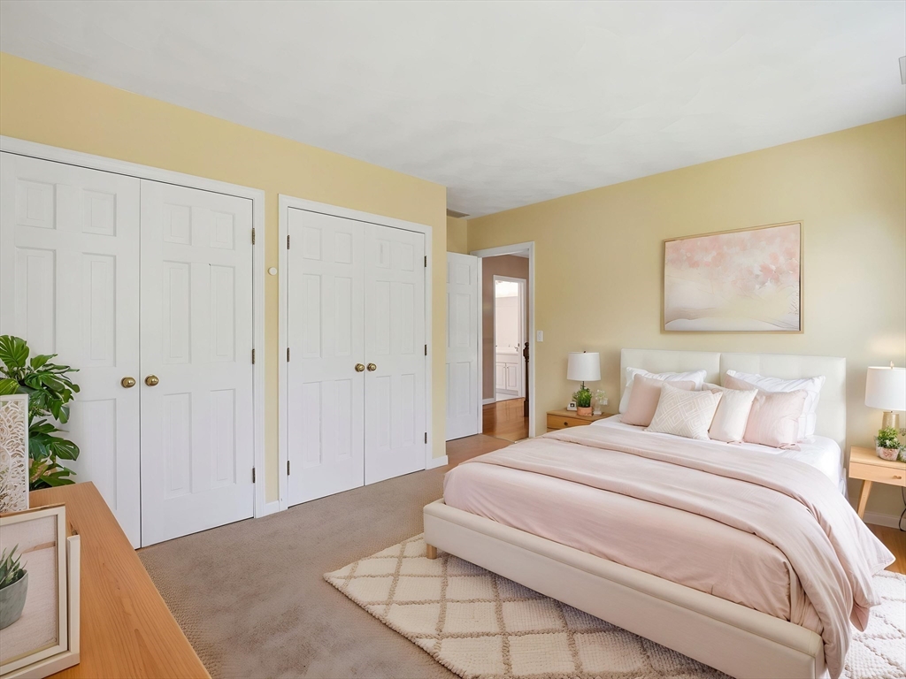 10 Hawk Ridge Road Andover, MA 01810 - Photo 18 of 32 a bedroom with a bed and a potted plant