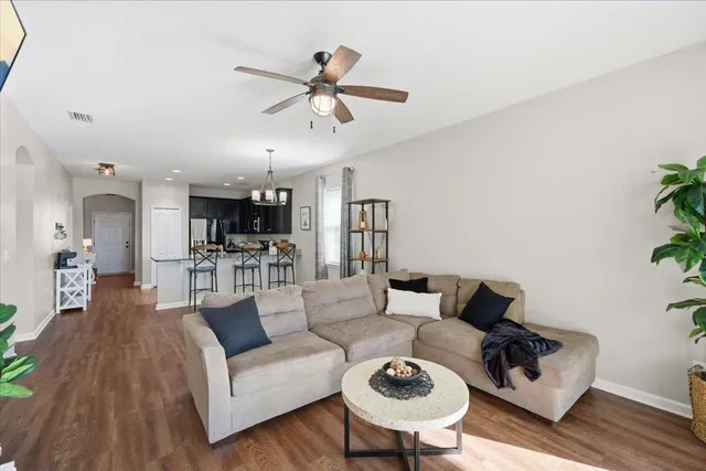 a living room with furniture and kitchen view