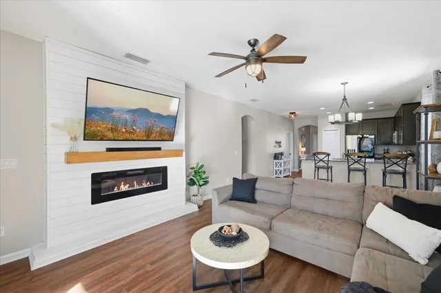 a living room with furniture a fireplace and a flat screen tv
