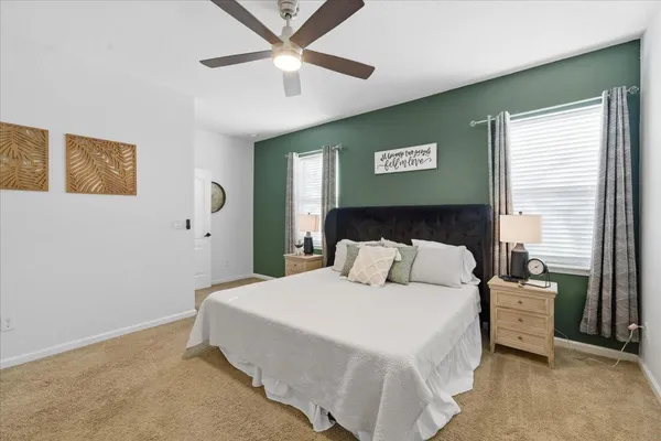 a bedroom with a large bed and a chandelier
