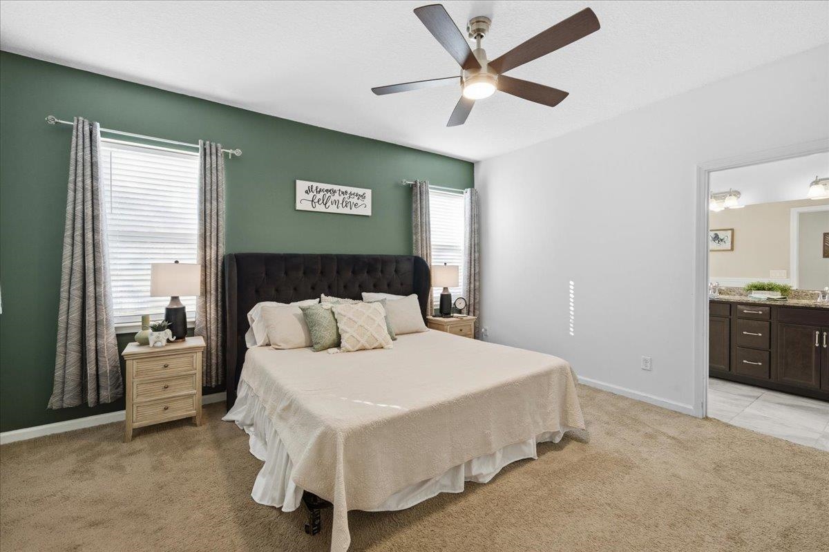 30 Levante Way St. Augustine, FL 32086 - Photo 21 of 40 a bedroom with a large bed and a chandelier