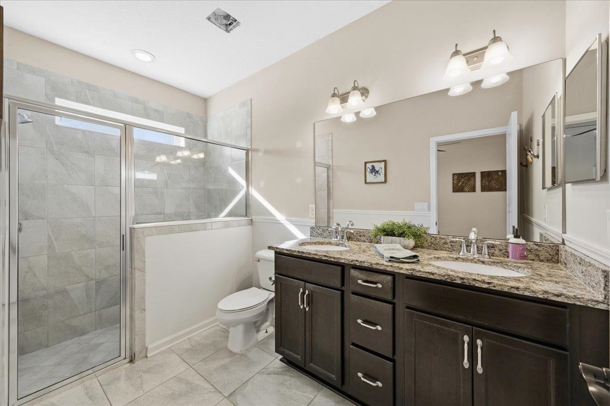 30 Levante Way St. Augustine, FL 32086 - Photo 22 of 40 a bathroom with a double vanity sink toilet mirror and shower