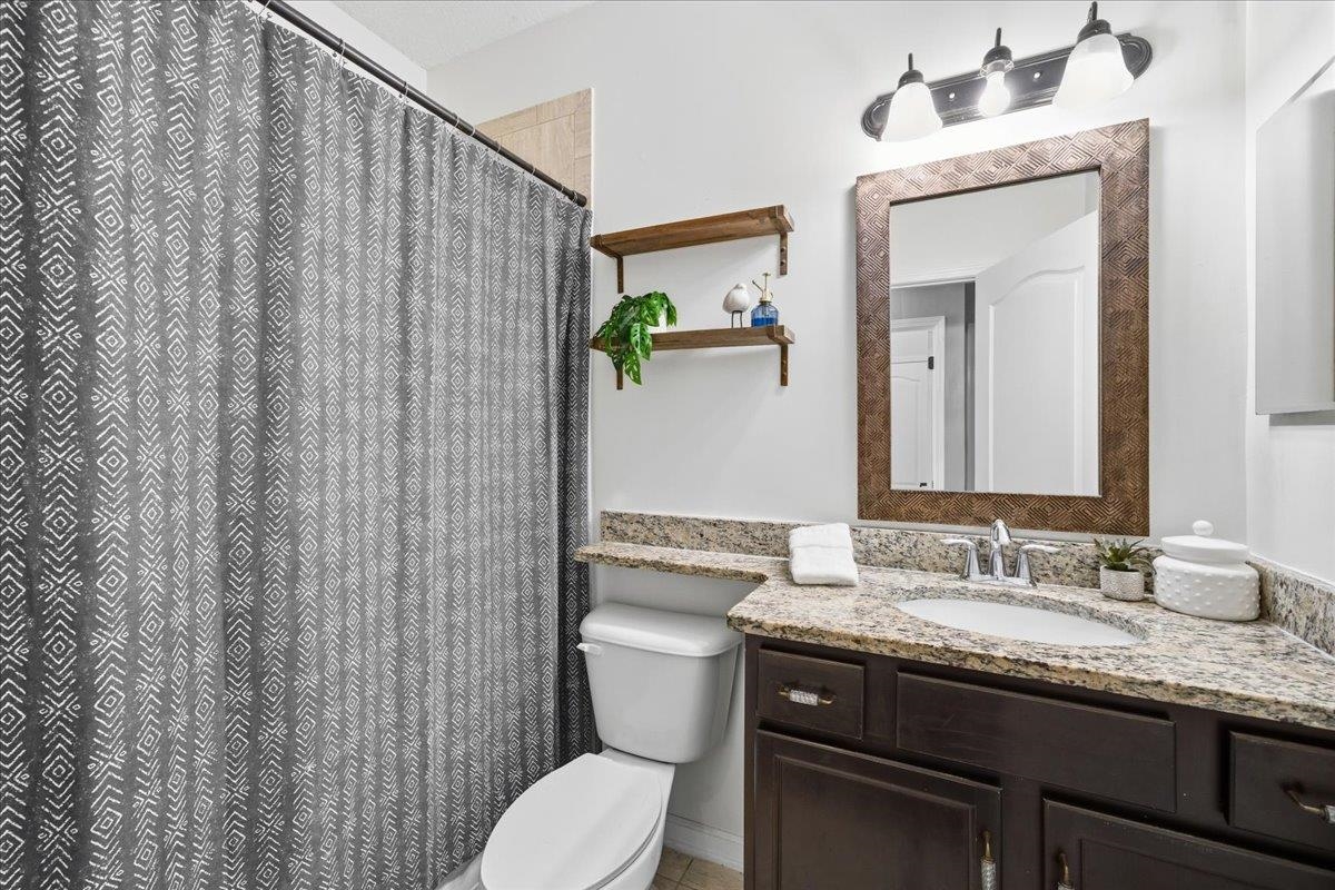 30 Levante Way St. Augustine, FL 32086 - Photo 27 of 40 a bathroom with a granite countertop toilet sink and mirror