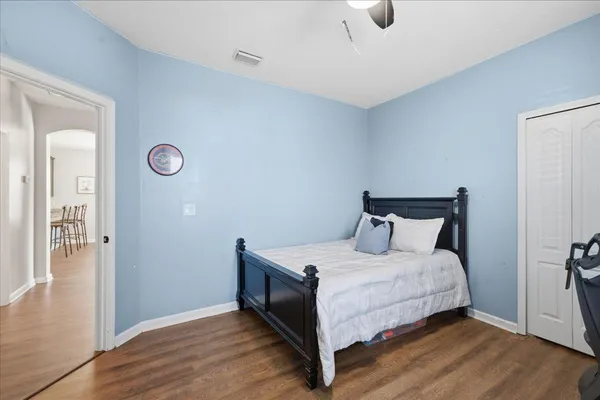a bedroom with a bed and wooden floor