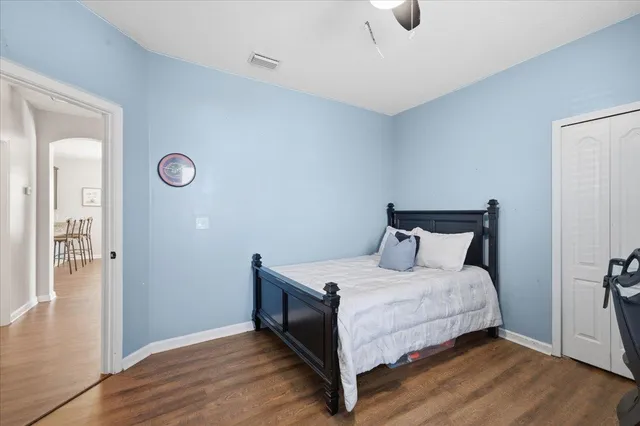 a bedroom with a bed and wooden floor
