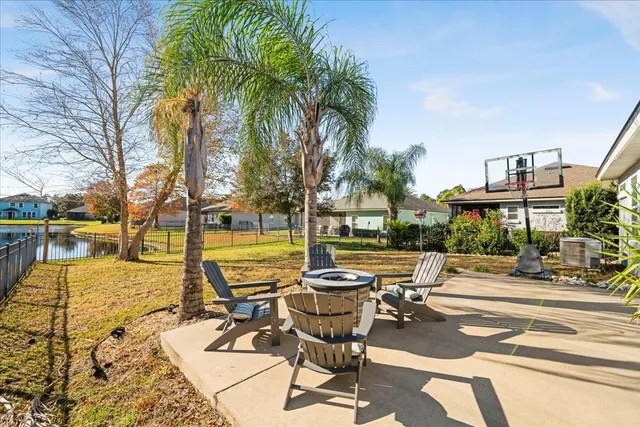 a view of a swimming pool with lounge chairs in patio