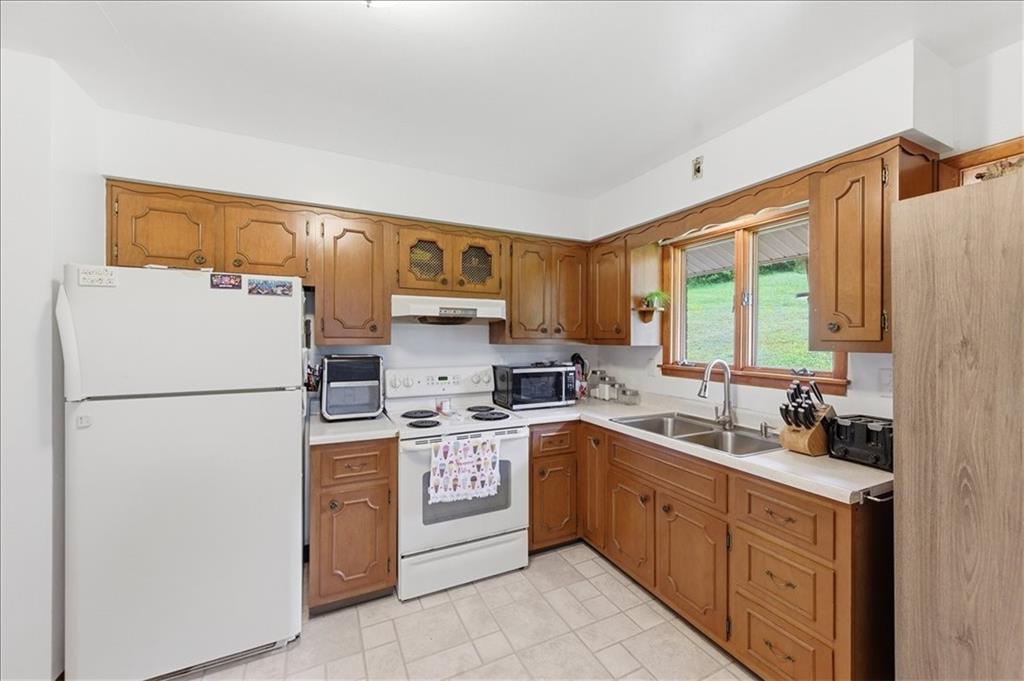 795 Geidel Road Ford City, PA 16226 - Photo 11 of 35 a kitchen with a sink a refrigerator and cabinets