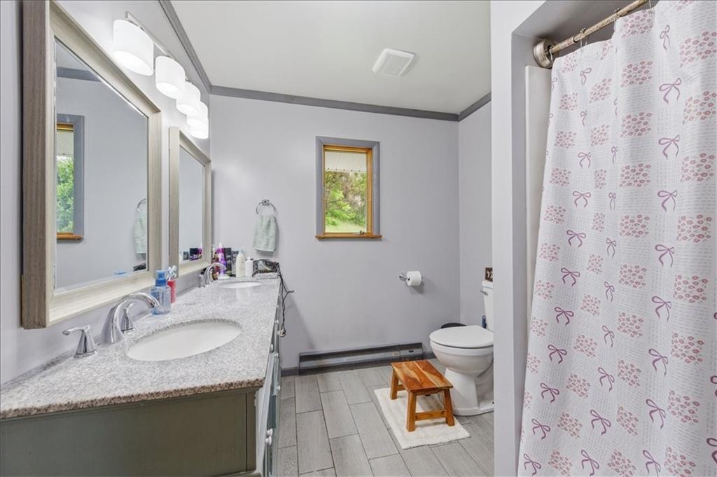 795 Geidel Road Ford City, PA 16226 - Photo 21 of 35 a bathroom with a granite countertop sink mirror vanity and toilet